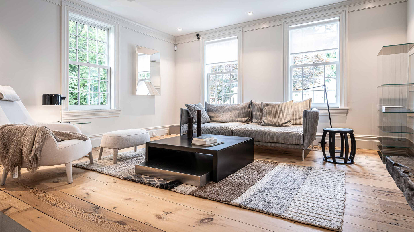 JANGEORGe Interiors & Furniture Moroso Gentry Sofa, Maxalto Side Table, Zeus Coffee Table, Maxalto & B&B Italia Armchair, Glas Italia Mirror and Storage Unit, Arno Declercq candle holders, Gandia Rugs in the front living room of our private residence.